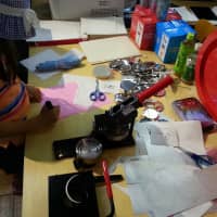 Group work: A young girl makes buttons at last year\'s Comic Art Tokyo. | COURTESY OF COMIC ART TOKYO