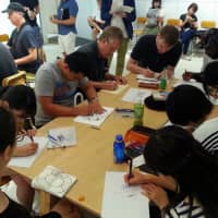 Come together: A group of artists work together on a drawing. Organizers believe that one of the best things to come out of Comic Art Tokyo is the camaraderie between illustrators. | COURTESY OF COMIC ART TOKYO