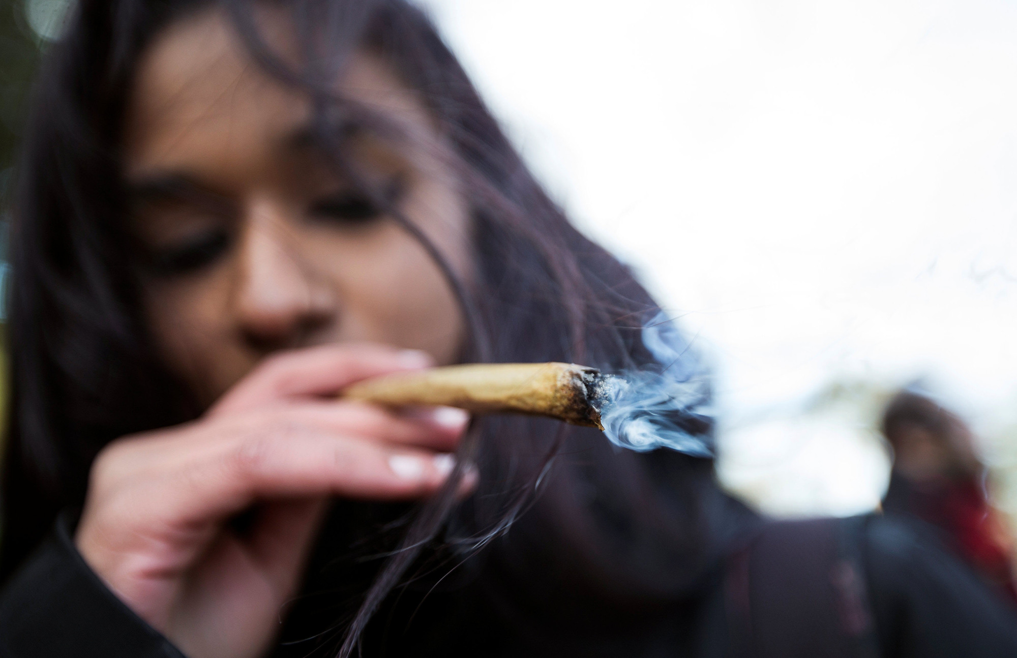 Legal high: A woman smokes a joint in Montreal on Oct. 17, the day Canada legalized marijuana for recreational use. | REUTERS