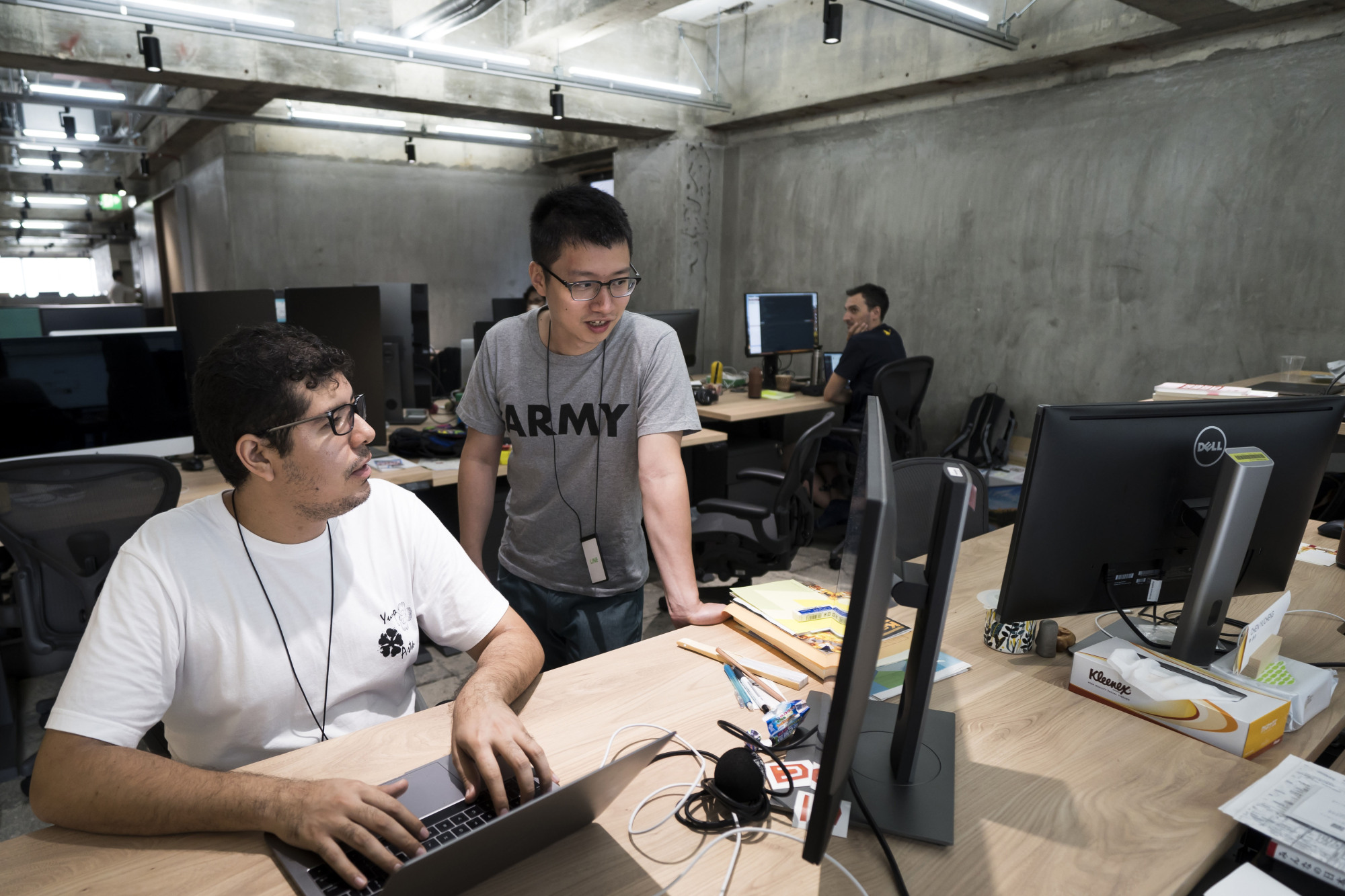 Carlos Perez Gutierrez (left), an engineer, speaks with a colleague at Line Corp.'s R&amp;D facility in Kyoto. A small number of Japanese companies are now looking both inside and outside Japan for their new hires. | BLOOMBERG