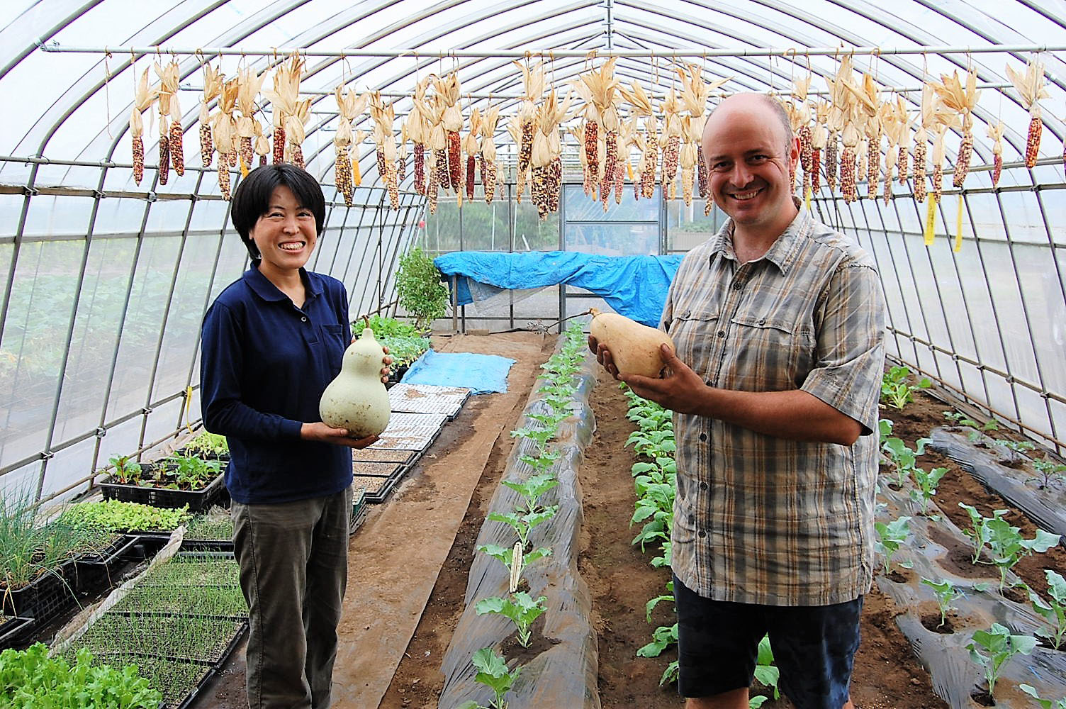 The good life: Atsue Durrant and her husband, Cameron, show their squash crop inside a green house at Base Side Farm near Yokota Air Base. | KYODO