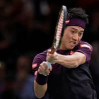 Kei Nishikori returns the ball against Roger Federer during the Paris Masters quarterfinals on Friday in Paris. | REUTERS