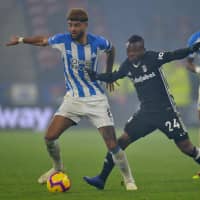 Huddersfield\'s Philip Billing (left) and Fulham\'s Jean Michael Seri compete for possession on Monday at John Smith\'s Stadium. | REUTERS