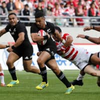 New Zealand\'s Richie Mo\'unga runs through the Japan defense during their test match at Ajinomoto Stadium on Saturday afternoon. | AP