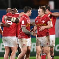 Canadian players celebrate after their 2019 Rugby World Cup-qualifying victory over Hong Kong on Friday in Marseille, France. | AFP-JIJI