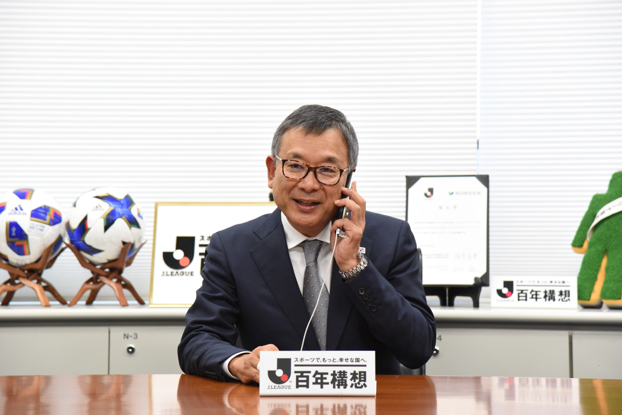 J. League chairman Mitsuru Murai informs Vanraure Hachinohe chairman Kentaro Hosogoe by phone of the league's decision to admit Vanraure as its 55th club on Tuesday. | DAN ORLOWITZ