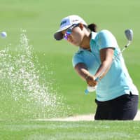 Nasa Hataoka plays a shot out of a bunker in the first round of the CME Group Tour Championship in Naples, Florida, on Thursday. Hataoka is one shot off the lead. | KYODO