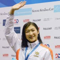 Rikako Ikee waves to fans after setting a new national record in the women\'s 100-meter freestyle at the Kosuke Kitajima Cup on Sunday. | REUTERS