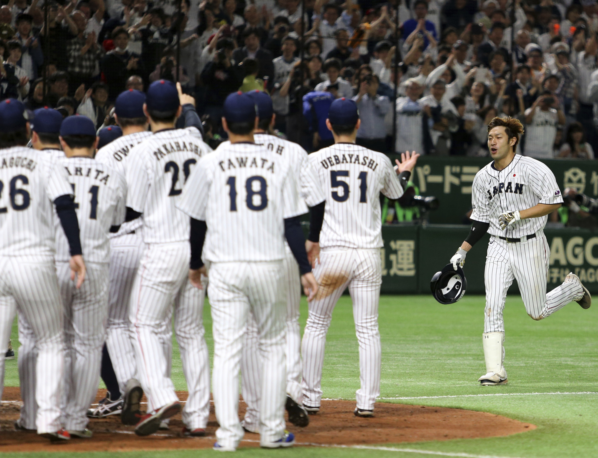 Samurai Japan's Yuki Yanagita heads home after blasting a two-run walk-off home run in the ninth inning off MLB All-Stars closer Kirby Yates on Friday at Tokyo Dome. Japan won 7-6. | AP