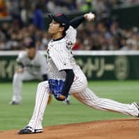 Samurai Japan hurler Takayuki Kishi fires a pitch in the first inning. | AP