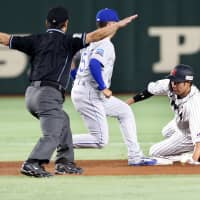Japan\'s Yuki Yanagita steals second as MLB All-Stars second baseman Whit Merrifield of the Kansas City Royals looks on in the fourth inning. | AP
