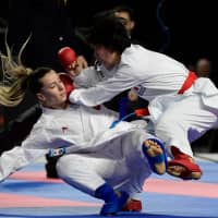 Miho Miyahara (right) fights with Turkey\'s Serap Ozcelik Arapoglu during the Kumite female 50kg competition at the 24th Karate World Championships in Madrid on Saturday. | AFP-JIJI