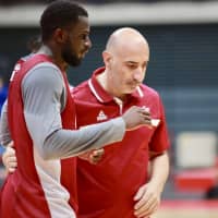 Qatar head coach Panayiotis Yiannaras talks with one of his players during the team\'s practice in Toyama on Thursday night. | KAZ NAGATSUKA