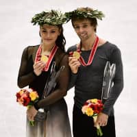 Gold medallists Kaitlin Hawayek (left) and Jean-Luc Baker of the U.S. pose on the podium for the ice dance free dance event at the NHK Trophy in Hiroshima on Sunday. | AFP-JIJI