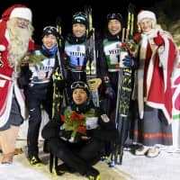Japan\'s Nordic combined team of Hideaki Nagai (left), Akito Watabe (center), Yoshito Watabe (right) and Go Yamamoto (sitting) pose with Santa Claus (left) and Mother Christmas after placing second at the World Cup season opener in Ruka, Finland. | KYODO