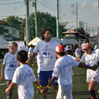 Former Japan player Hitoshi Ono takes part in a training clinic along with children from Lindfield Rugby Club in Australia, Glenmark-Cheviot Rugby Club in New Zealand, and rugby schools from Kanagawa Prefecture at a Heroes Cup event at Yokohama Country and Athletic Club on Sunday. | RICH FREEMAN