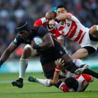 Japanese players converge on England\'s Maro Itoje during their match on Saturday in London. England won 35-15. | ACTION IMAGES VIA REUTERS