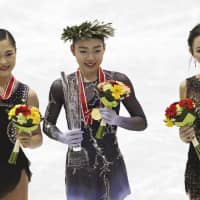 Silver medalist Satoko Miyahara (left), gold medalist Rika Kihira (center) and third-placed finisher Elizaveta Tuktamysheva of Russia pose for a photo during an awards ceremony at the NHK Trophy in Hiroshima on Saturday. | AP