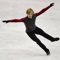 Russia\'s Sergei Voronov pays tribute to the late Denis Ten with his rendition of \"Way Down We Go\" in the men\'s free skate on Saturday. | AFP-JIJI