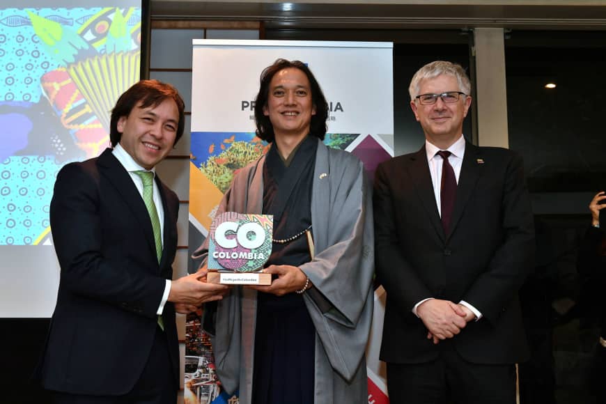 Takanori Nakamura (center) receives a plaque for his appointment as 