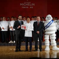 Sushi chef Yoshikazu Ono from Sukiyabashi Jiro Honten in Tokyo poses with a plaque he received for maintaining the restaurant\'s status of having three Michelin stars. This year\'s Michelin Guide again makes Tokyo the No.1 culinary city in the world. | RYUSEI TAKAHASHI