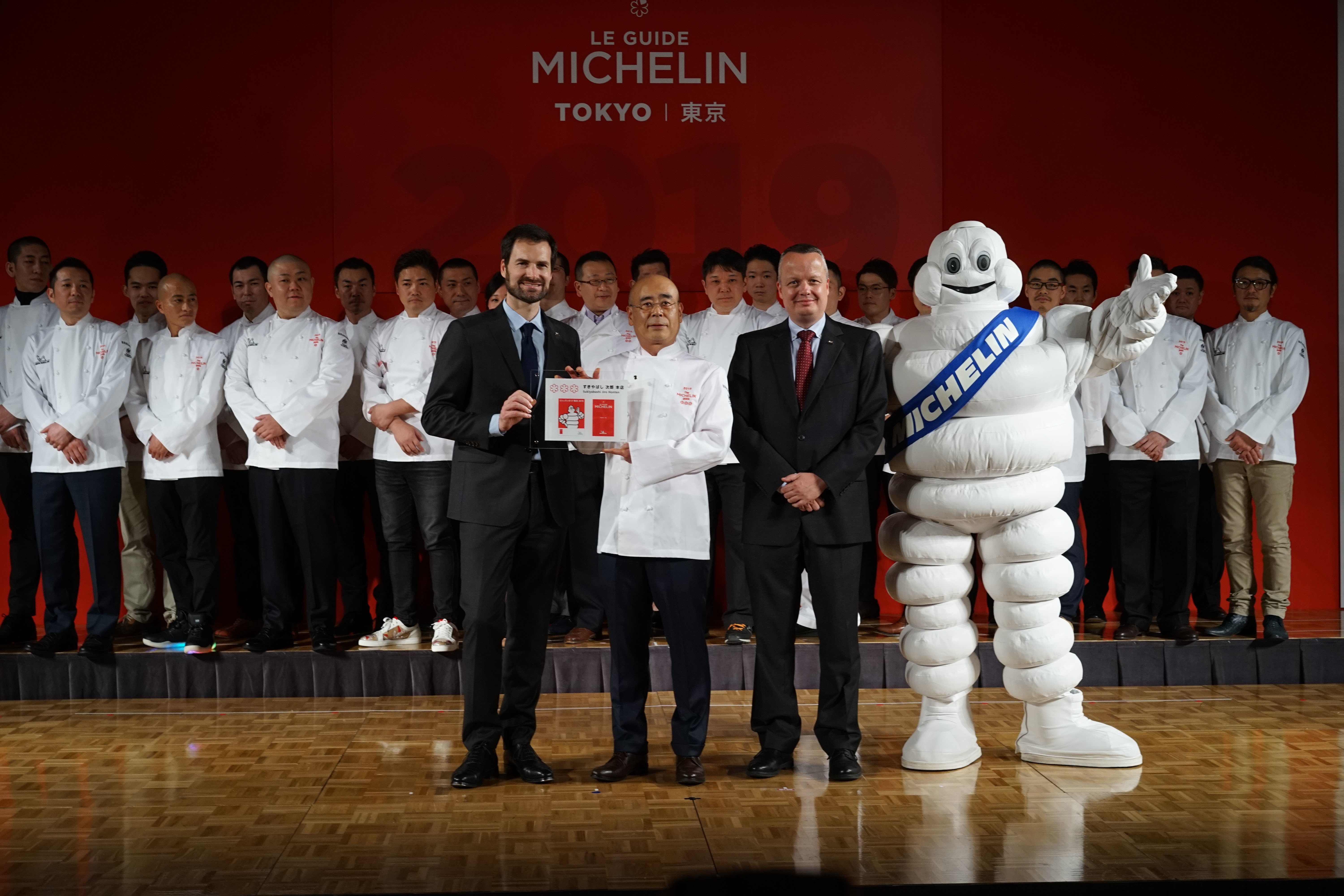 Sushi chef Yoshikazu Ono from Sukiyabashi Jiro Honten in Tokyo poses with a plaque he received for maintaining the restaurant's status of having three Michelin stars. This year's Michelin Guide again makes Tokyo the No.1 culinary city in the world. | RYUSEI TAKAHASHI
