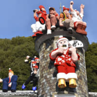 Figures of people who made headlines this year, including North Korean leader Kim Jong Un and U.S. President Donald Trump shaking hands (left) and Los Angeles Angels star Shohei Ohtani (left on top of chimney), are displayed Wednesday at the Uroko House in Kobe\'s Ijinkan complex, which was built for foreign merchants after the opening of Kobe port in the 19th century. | KYODO