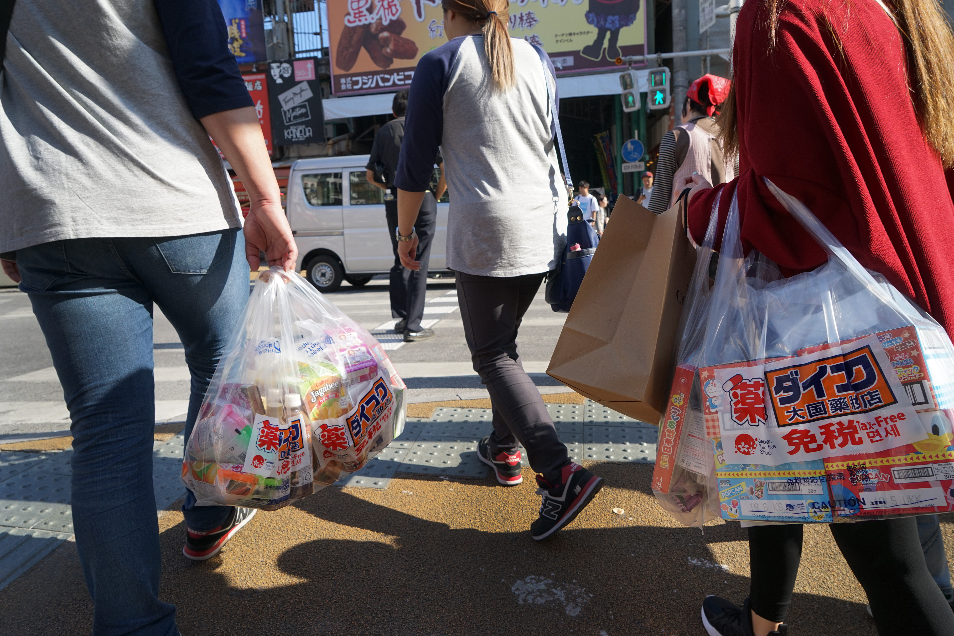 Tourists carry shopping bags in Naha, Okinawa. | BLOOMBERG