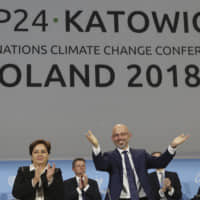 COP24 President Michal Kurtyka (second from right), and other officials after adopting the final agreement at the U.N. climate change conference in Katowice, Poland, on Dec. 15. | AP