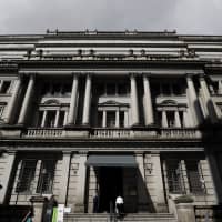 The Bank of Japan will likely wait until after next year\'s consumption tax hike before taking action to tighten monetary policy, according to a recent Bloomberg survey on economists. | BLOOMBERG