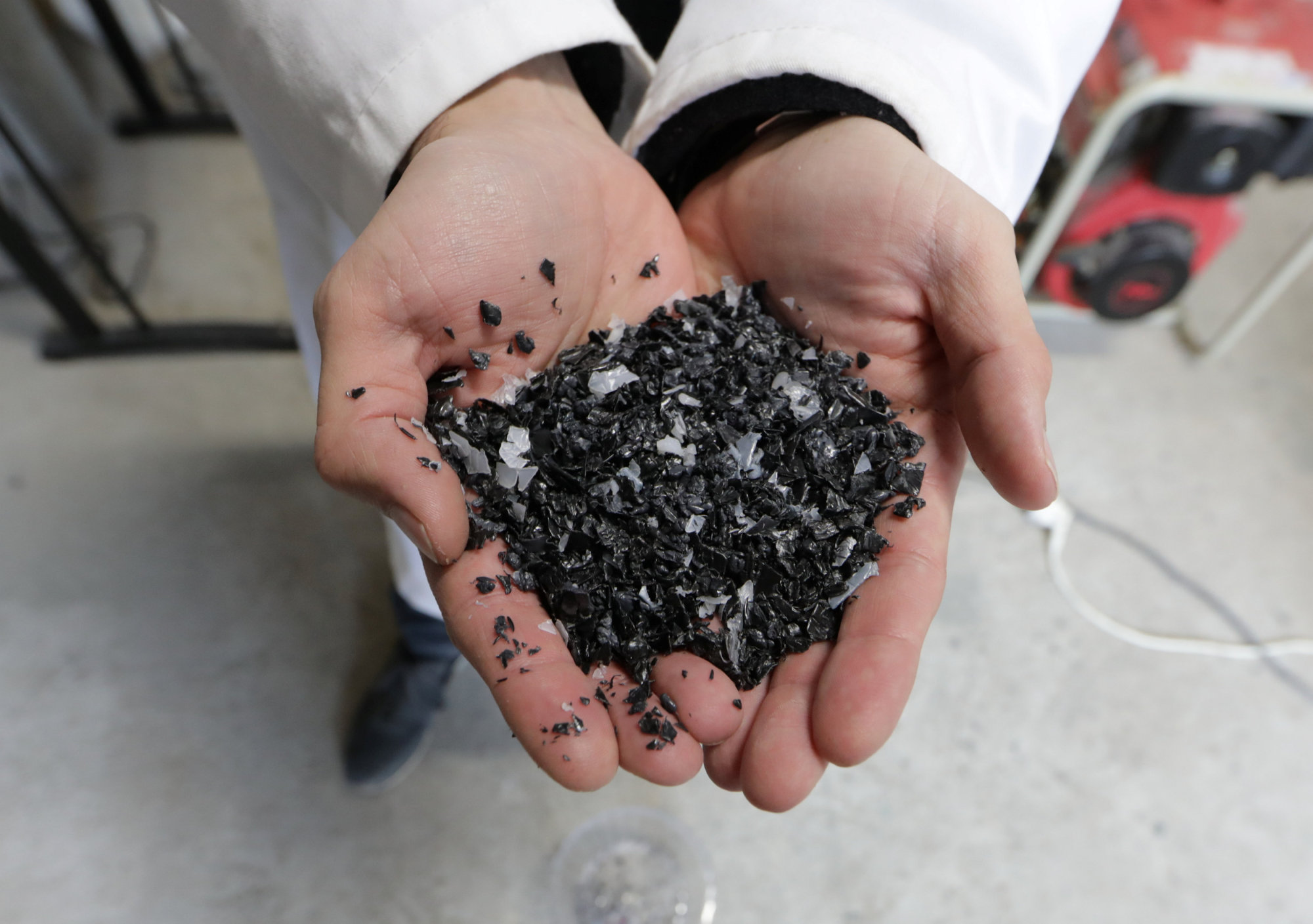 Christofer Costes, a French inventor who created a machine that turns plastic waste into fuel, displays pieces of plastic in Puget-Theniers, France, Dec. 14. | REUTERS