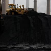 A bulldozer moves coal at the Murray Energy Corp. port facility in Powhatan Point, Ohio, in November 2017. | REUTERS