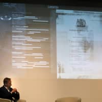 Alex Younger, chief of the Secret Intelligence Service, known as MI6, delivers a speech at the University of St Andrews, Scotland, Monday. | REUTERS