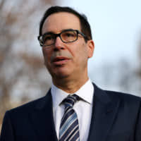 U.S. Treasury Secretary Steven Mnuchin speaks to media representatives following a TV interview at the White House on Dec. 3. | REUTERS