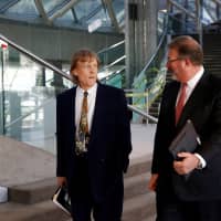 Chairman David Thomson (left) walks with CEO Jim Smith during the Thomson Reuters Corp. annual general meeting for shareholders in Toronto in 2017. | REUTERS