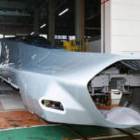 Car No. 1 of the ALFA-X, the next generation of shinkansen, is shown to the media Wednesday at a production factory in Kobe. East Japan Railway Co. will trial the ALFA-X, which will boast a top operational speed of 360 kph, on the Tohoku Shinkansen line after its production is completed in May. | KYODO