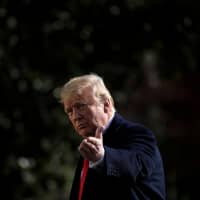 U.S. President Donald Trump points to the press while walking to Marine One on the South Lawn of the White House in Washington Nov. 29. Trump on Tuesday renewed his attack on the Federal Reserve\'s monetary policy, blaming the central bank\'s interest rate hikes for a tanking market. With stocks on track for their worst December since the Great Depression, Trump has regularly berated the Fed for its stewardship of the economy. | AFP-JIJI