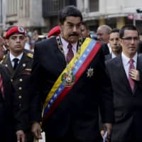 Venezuelan President Nicolas Maduro (center) arrives at the national assembly in Caracas in 2015. Maduro on Monday said to the national assembly that he was recalling Venezuela\'s ambassador in neighboring Guyana for consultations amid an escalating row over oil exploration in disputed offshore territory. Exxon Mobil Corp. had said it had discovered oil off Guyana\'s coast, spurring complaints from Caracas that Guyana is unfairly exploiting a disputed territory. | REUTERS