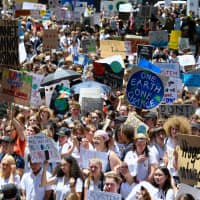 Children who walked out of school protest against government inaction on climate change in Sydney on Friday. | REUTERS