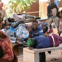 Patients wait in the Connaught Hospital courtyard to be called for treatment or bed assignments in Freetown Wednesday. | REUTERS