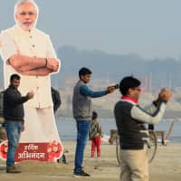 A cardboard cut-out of Indian Prime Minister Narendra Modi stands at the Kumbh Mela festival area in Allahabad on Thursday. The  event attracts millions of Hindu pilgrims to the sacred confluence of the Yamuna and Ganges rivers, where they will take ritual baths over 49 days from Jan. 15 until March 4. | AFP-JIJI