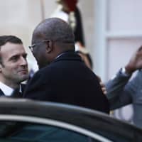 French President Emmanuel Macron (left) accompanies Burkina Faso President Roch Marc Christian Kabore as he leaves after a meeting at the Elysee Palace on Monday in Paris. | AFP-JIJI
