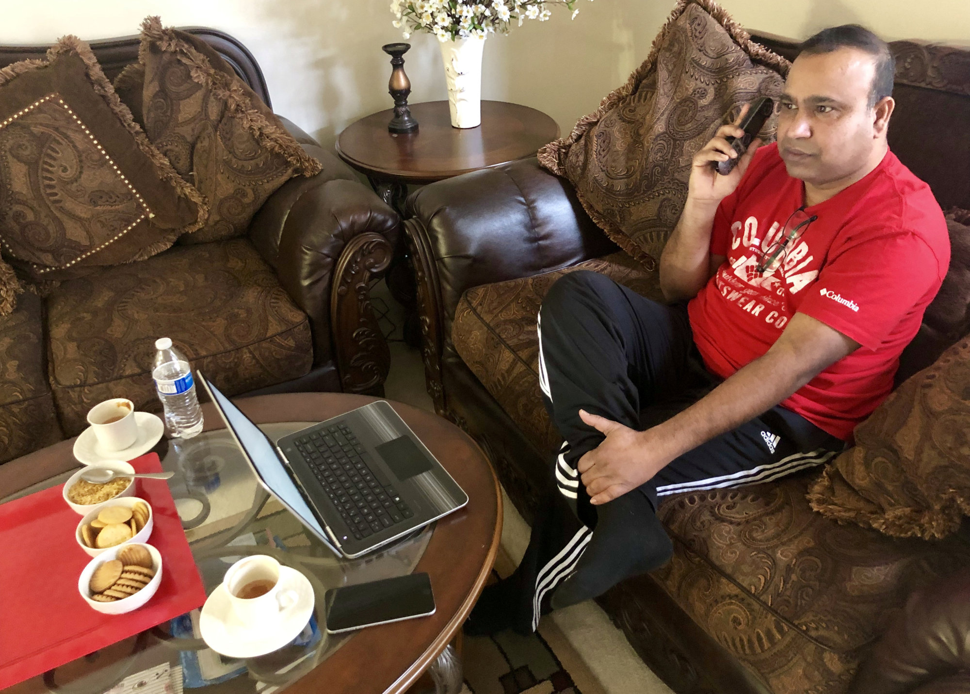 Madhu Bellam, a member of the Overseas Friends of BJP, calls potential voters in Hyderabad, India, from his home in Clarksburg, Maryland, on Dec. 2. | REUTERS