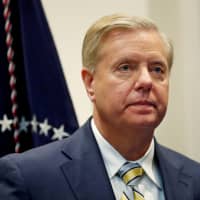 Sen. Lindsey Graham (R-SC) waits for U.S. President Donald Trump to enter the room to speak about the \"First Step Act\" in the Roosevelt Room at the White House in Washington Nov. 14. | REUTERS