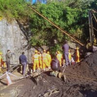 Rescuers work at the site of a coal mine that collapsed in Ksan, in the northeastern state of Meghalaya, India, Sunday. | REUTERS