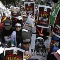 Muslim protesters rally outside the Chinese Embassy in Jakarta, Indonesia, on Friday, | AP