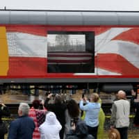 Spectators watch as the Union Pacific funeral train carrying the casket of former President George H.W. Bush passes through Navasota, Texas, Thursday. | REUTERS