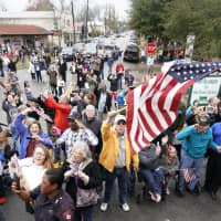 People pay their respects as the train carrying the casket of former President George H.W. Bush passes Thursday along the route from Spring to College Station, Texas. | AP