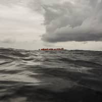 Refugees and migrants wait to be rescued by aid workers from the Spanish NGO Proactiva Open Arms, 60 miles north of Al-Khums, Libya, on Feb. 18 after leaving Libya aboard an overcrowded rubber boat in an attempt to reach European soil. | AP