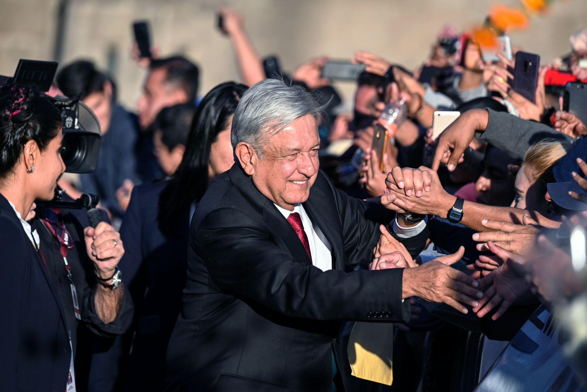 Andres Manuel Lopez Obrador greets supporters during Mexico's 58th presidential inauguration event at Mexico City's central plaza, the Zocalo, on Saturday. | BLOOMBERG